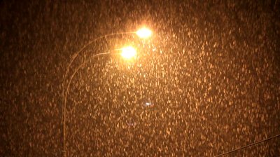 stock-footage-plentiful-snowfall-in-front-of-street-light